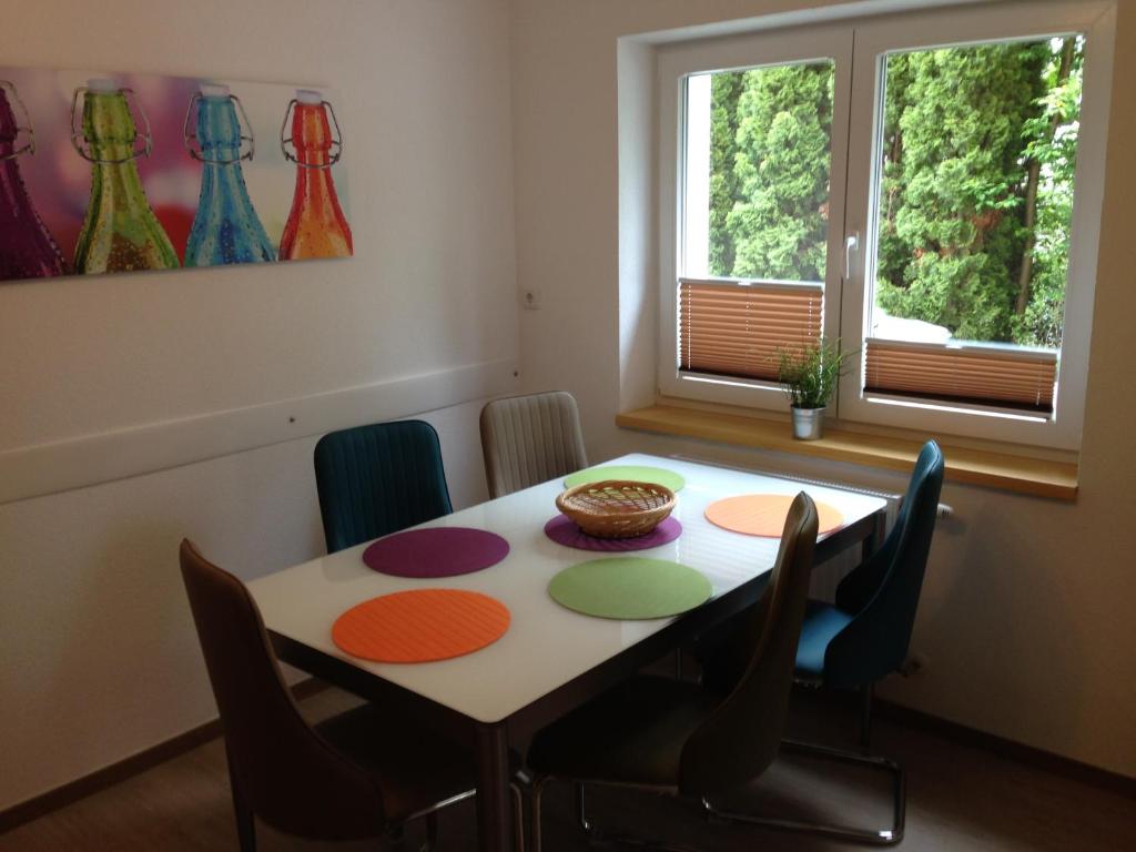 a dining room with a table and chairs and windows at Appartement Luna in Mittersill