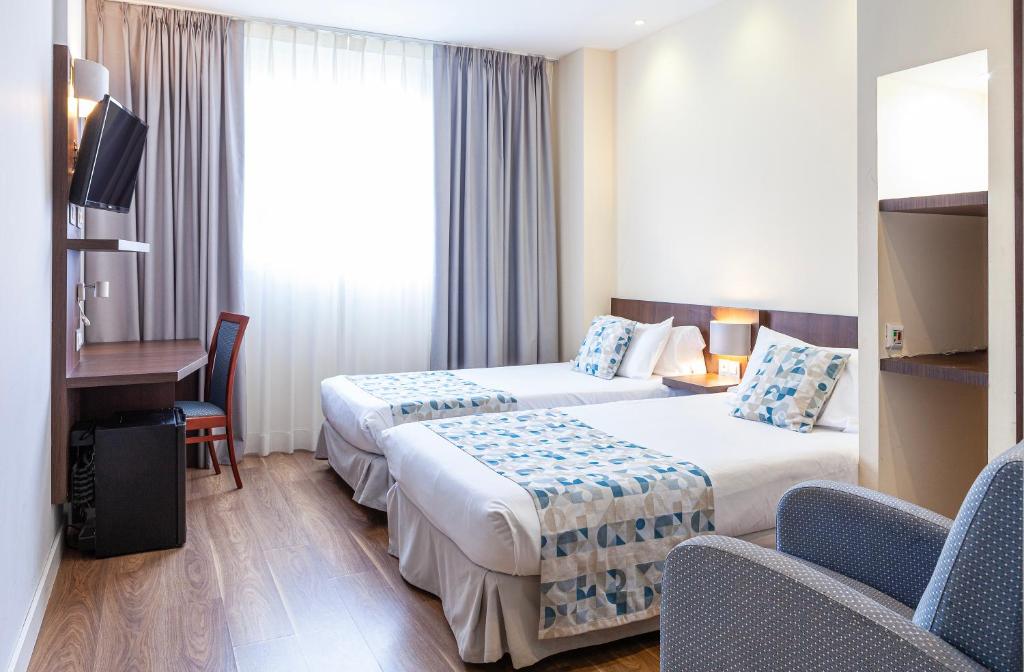 Postel nebo postele na pokoji v ubytování Hotel Olympia Universidades