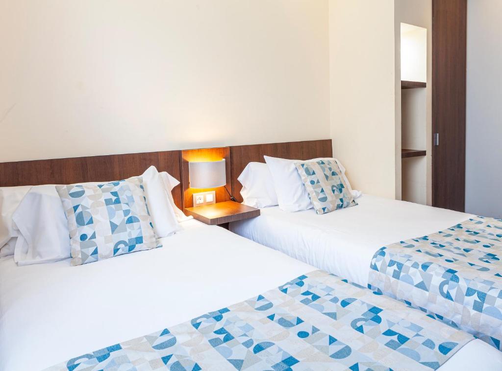 Postel nebo postele na pokoji v ubytování Hotel Olympia Universidades