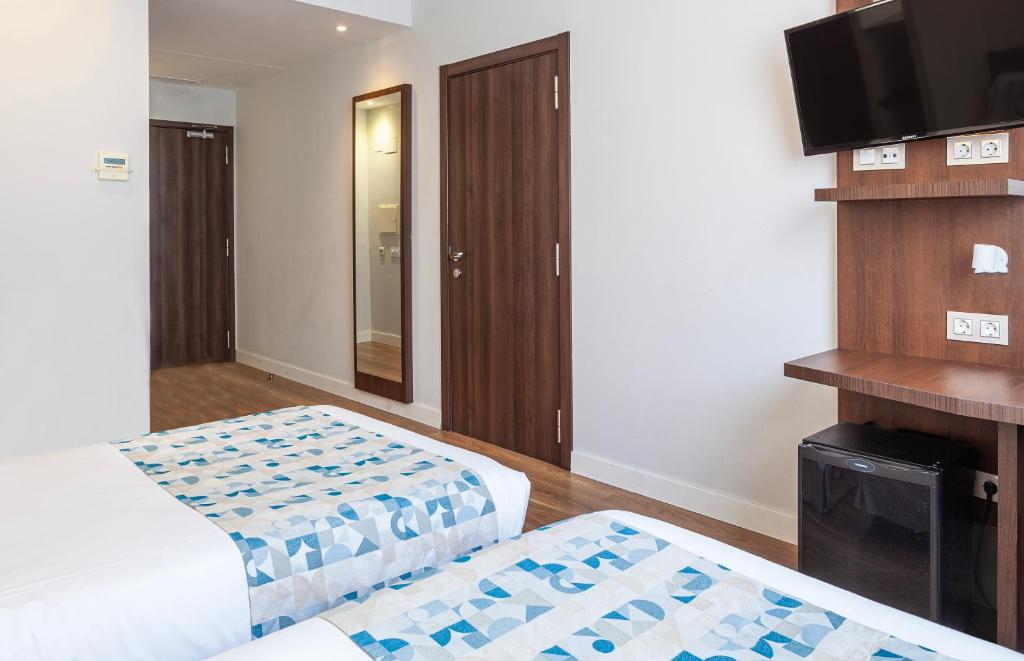 Postel nebo postele na pokoji v ubytování Hotel Olympia Universidades