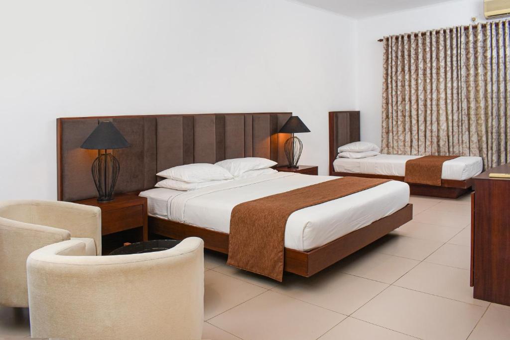 Postel nebo postele na pokoji v ubytování Joe's Resort Bentota