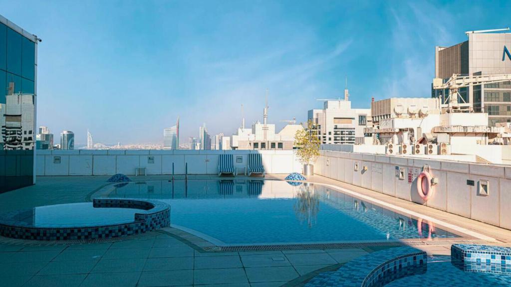 a large pool on top of a building with a city at Modern 1BR in Saba Tower 2 - Prime JLT Location in Dubai