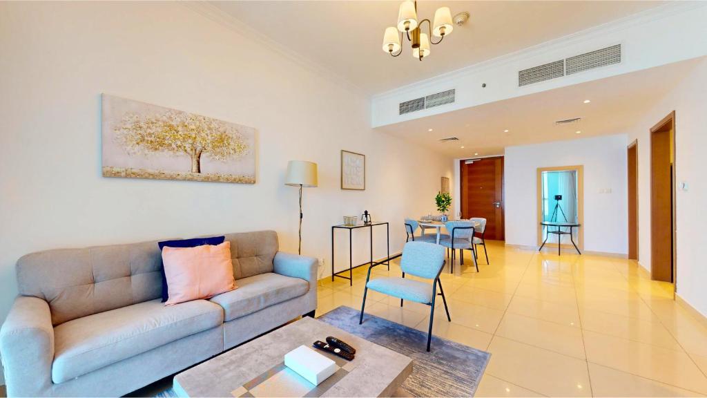 a living room with a couch and a table at Modern 1BR in Saba Tower 2 - Prime JLT Location in Dubai