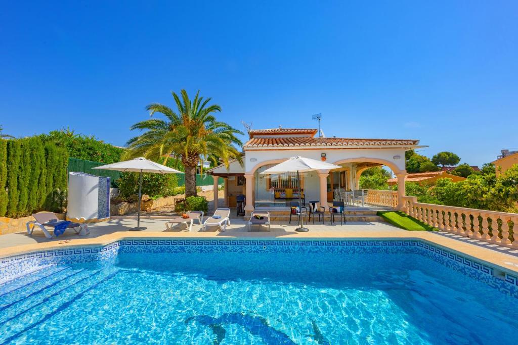 a villa with a swimming pool and a house at Villa Mona - PlusHolidays in Ifach