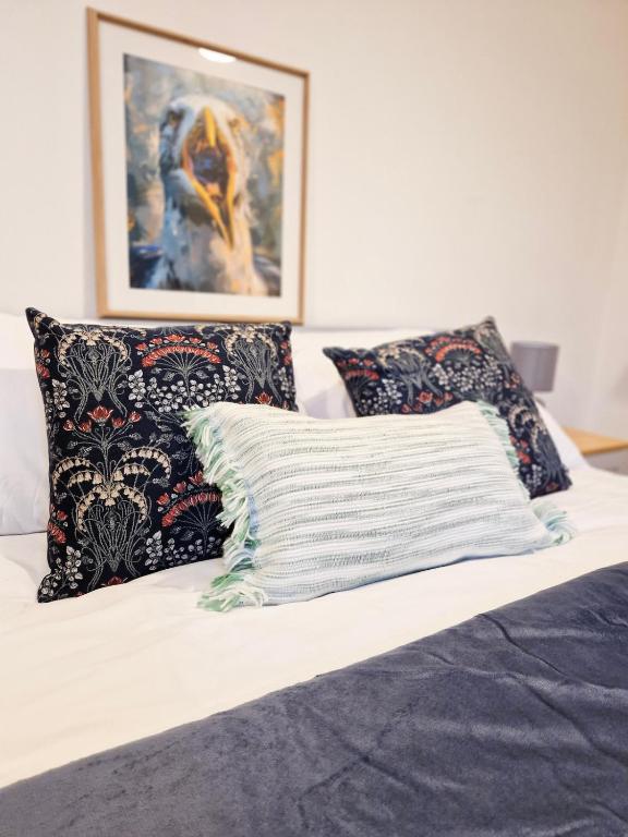 a bed with two pillows on top of it at The Dover House with river and Castle views in Dover