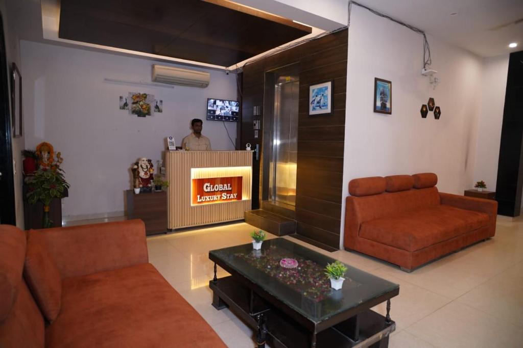 a living room with a couch and a table at GLOBAL Luxury Stay in Gurgaon