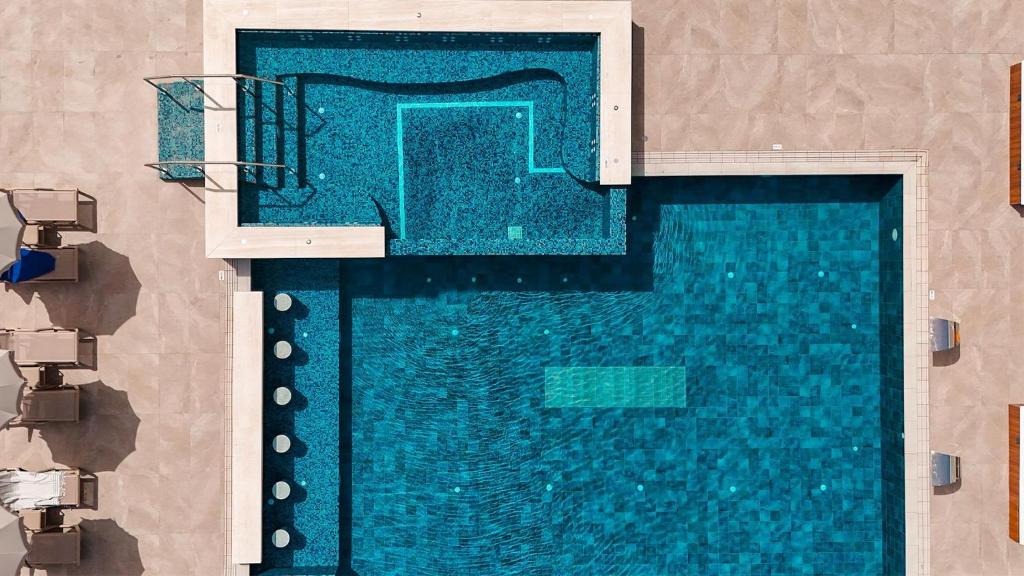 an overhead view of a swimming pool at Cavo Maris Beach Hotel in Protaras