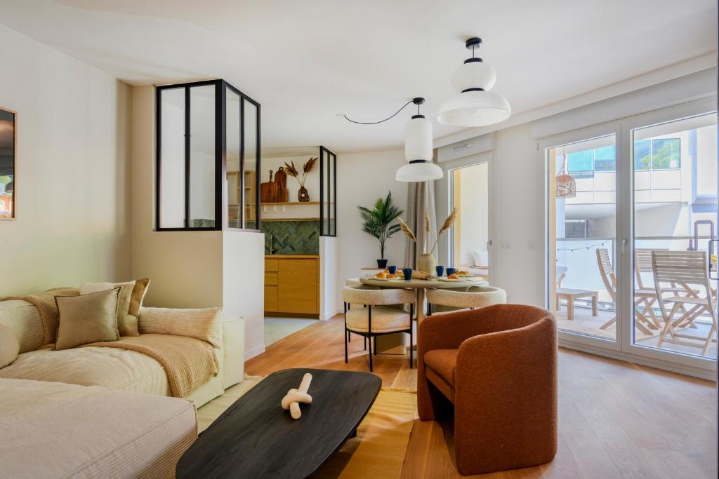 a living room with a couch and a table at Paris West Elegant residence in Suresnes