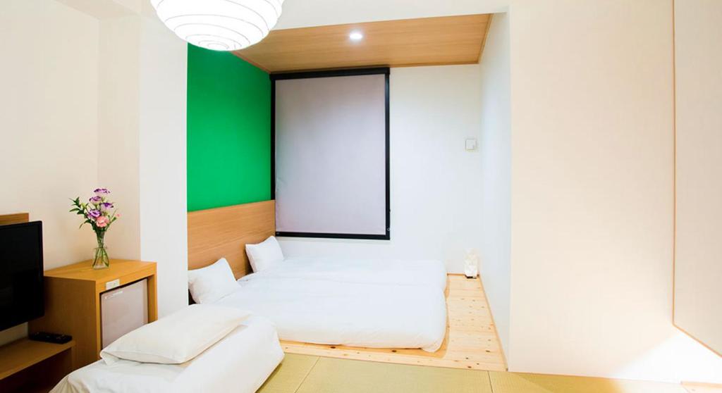 Postel nebo postele na pokoji v ubytování Hotel Meldia Kyotoshijoomiya