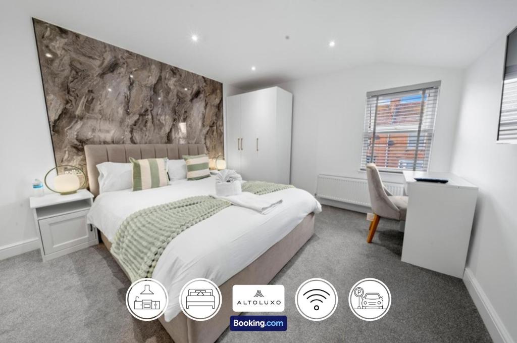 a bedroom with a large bed with a stone wall at No 26 6 Bedroom House By AltoLuxoExperience Short Lets & Serviced Accommodation With Free Wifi in Burnham on Sea
