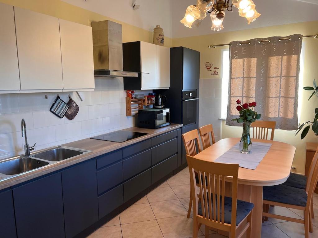 a kitchen with a wooden table and a kitchen with a sink at Test in Koper