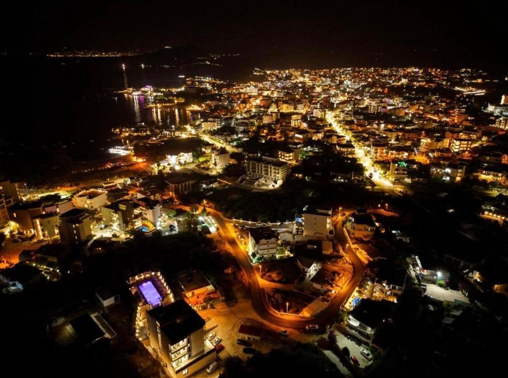 a view of a city at night with lights at Dine Hotel in Ksamil