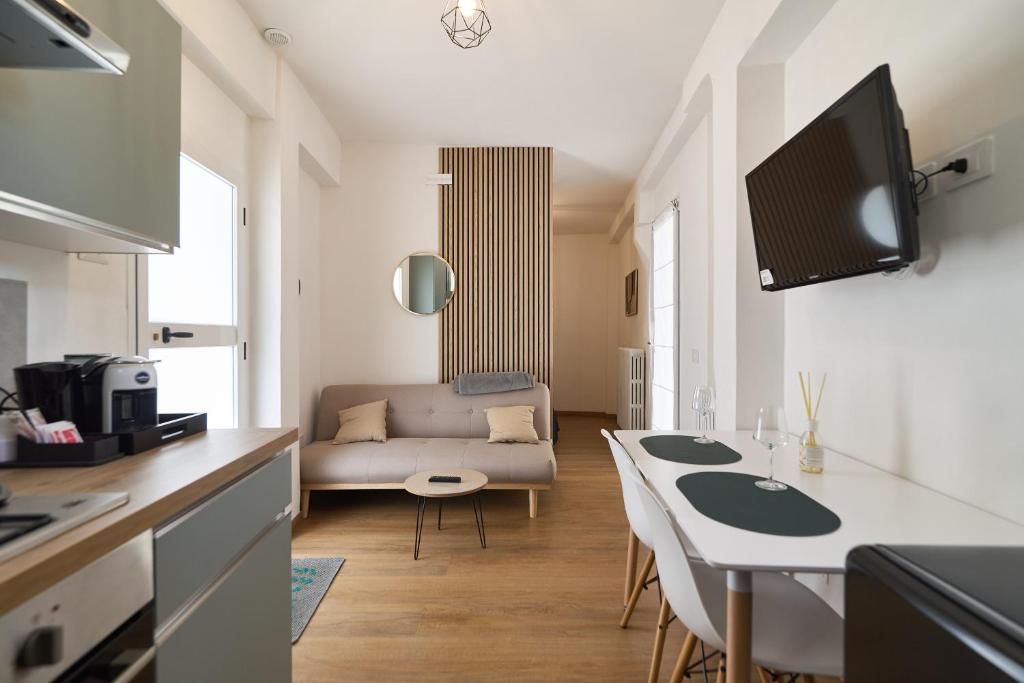a kitchen and living room with a couch and a table at Casa Giglio in Perugia