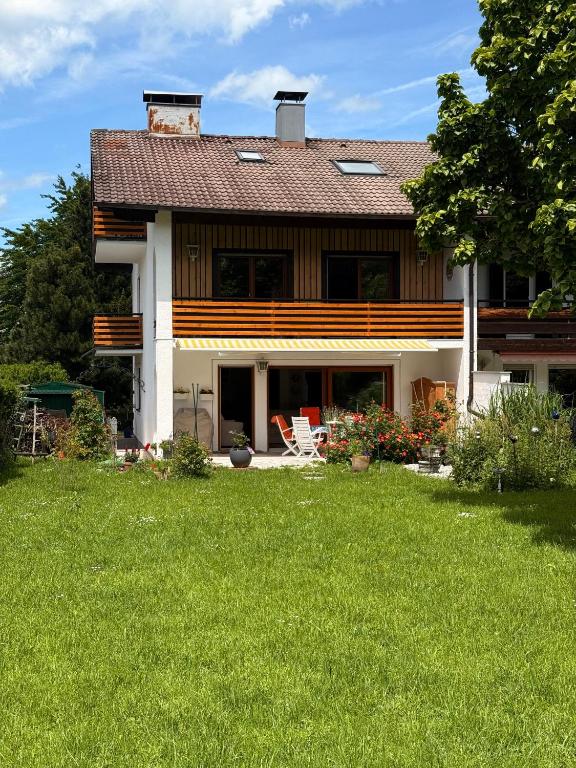 a house with a green yard with a house at Ferienhaus Sonnenschein in Bad Reichenhall
