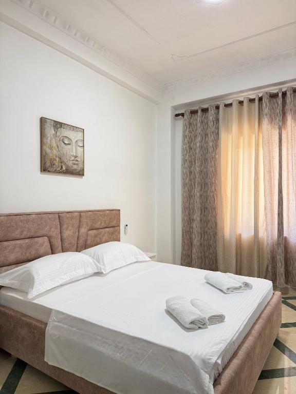 Postel nebo postele na pokoji v ubytování LM Murati Hotel