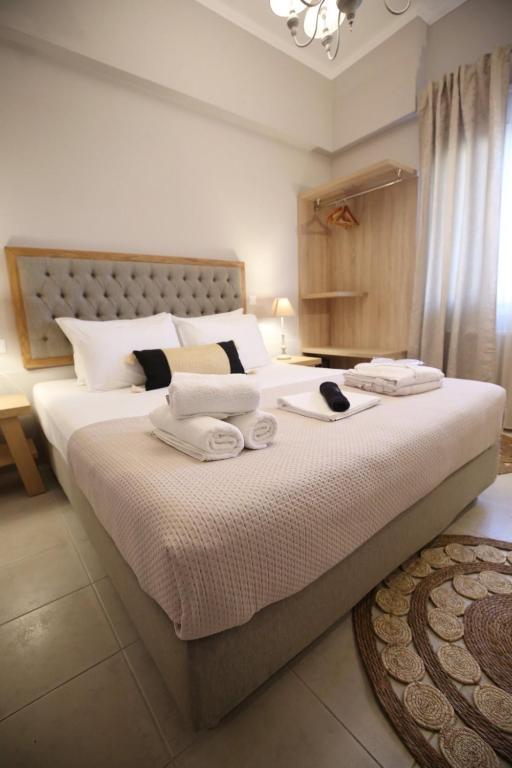 a bedroom with a large bed with two towels on it at ILIOS apartment in Nydri