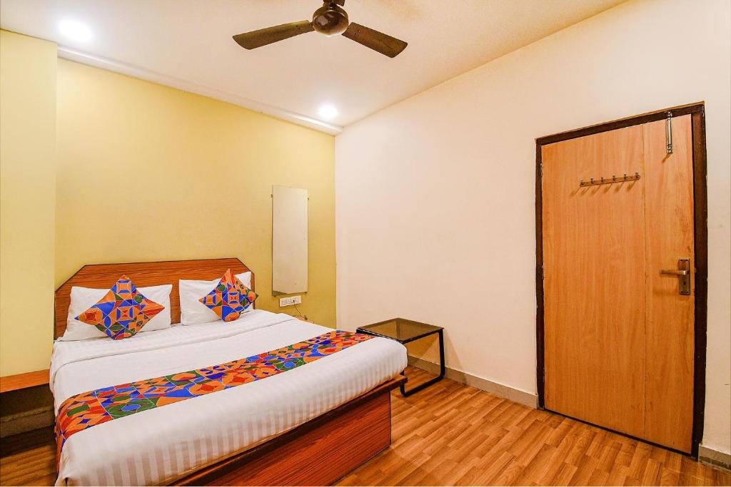 a bedroom with a bed and a ceiling fan at FabHotel Kamala Inn in Kotrung