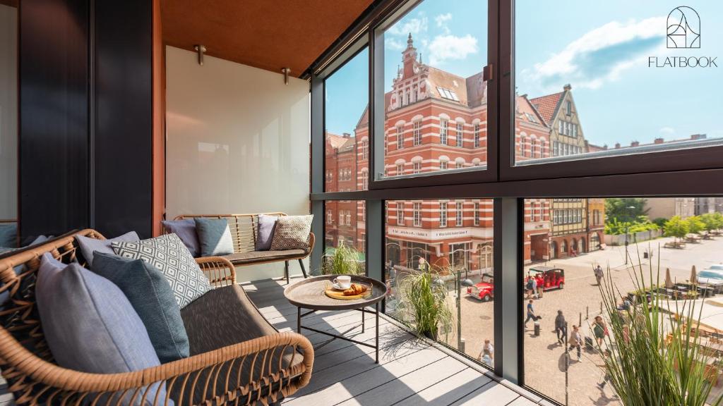 an apartment balcony with a view of a city at Flatbook - City Center SPA Apartments Deo Plaza Studio in Gdańsk