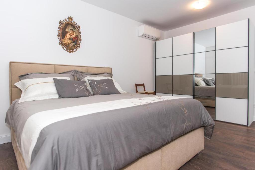 a bedroom with a large bed in a room at Villa Seget Large Villa all for you in Seget Vranjica