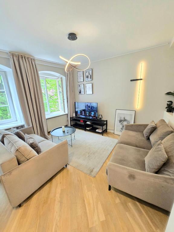 a living room with two couches and a table at Stylish Riga Old Town getaway in Riga