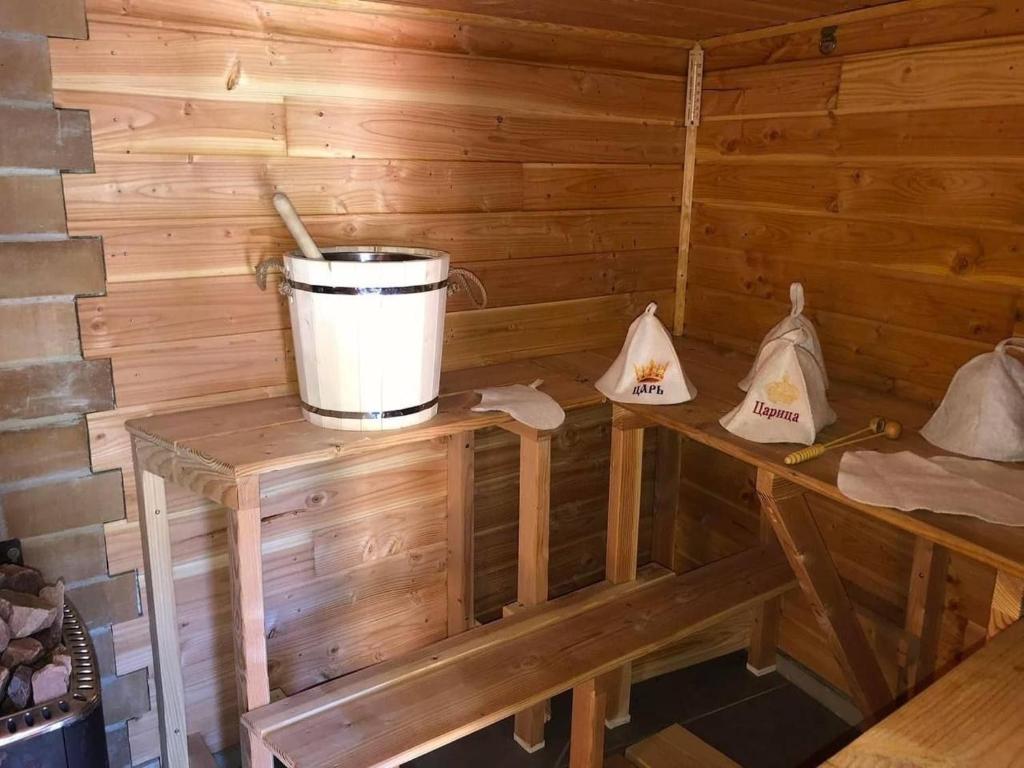 a small wooden cabin with a bucket on a table at Clos de la filature sauna et bien-être in Ronchamp