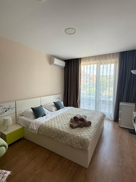 a bedroom with a bed with a teddy bear on it at Apartment Premier Fort Beach hotel F1 420 in Sveti Vlas