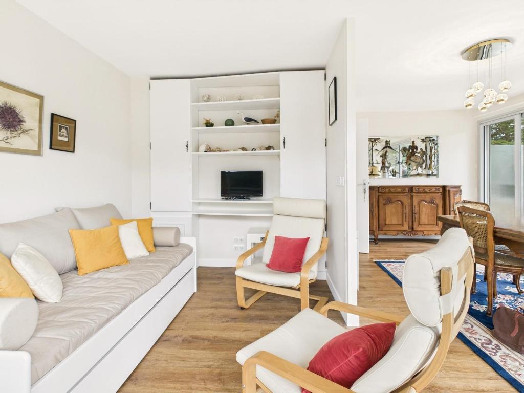 un salon avec un canapé et des chaises dans l'établissement 120 m de la plage- Appartement pour 4 - balcon, à La Baule