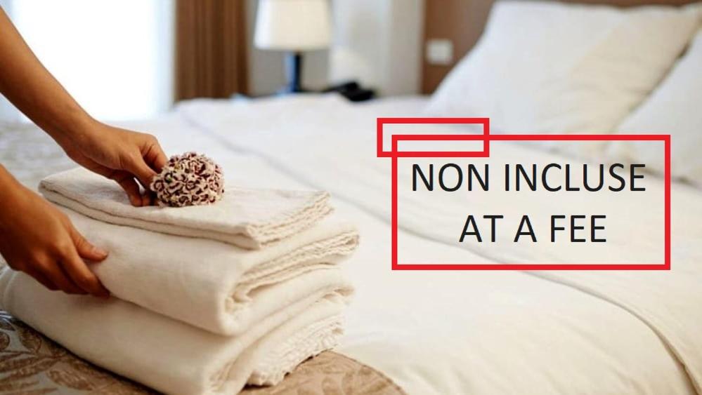 a person putting towels on a bed with the words non invoice at a fee at Villaggio Mietta in Castiglioncello
