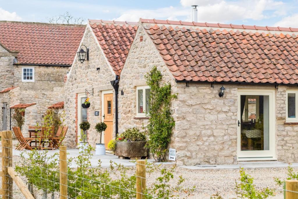 a row of stone cottages with red roofs at Grange Cottage in York