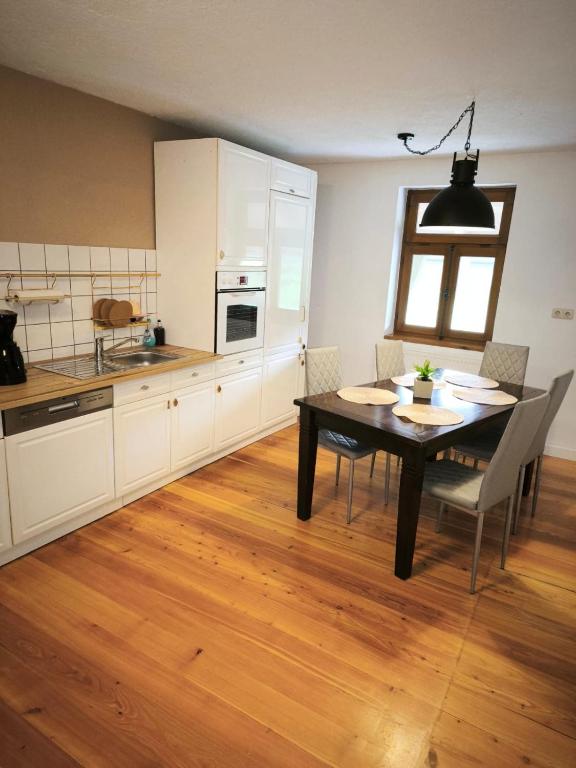 a kitchen with a table and a dining room at 4 Schlafzimmer Apartment in Neustadt
