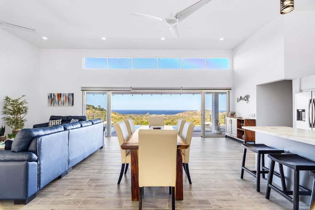 a kitchen and living room with a table and a couch at Ocean View Villa & Private Pool in Mar Vista in Brasilito