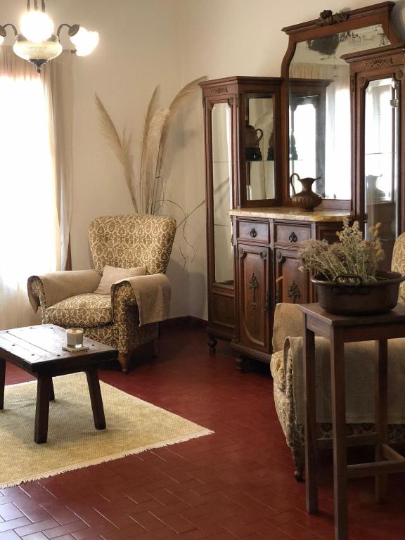 a living room with a chair and a mirror at Las Vellon in San Pedro