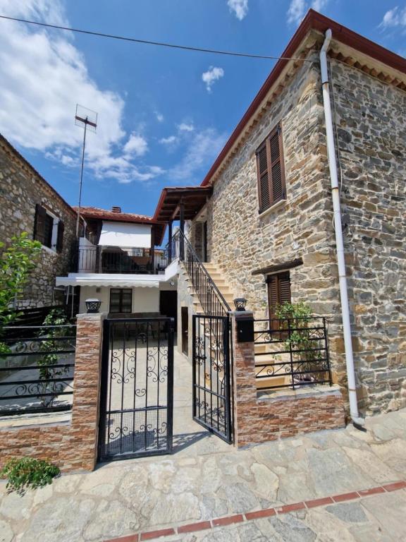 an image of a church with a gate at Anna Cozy Corner in Agios Nikolaos