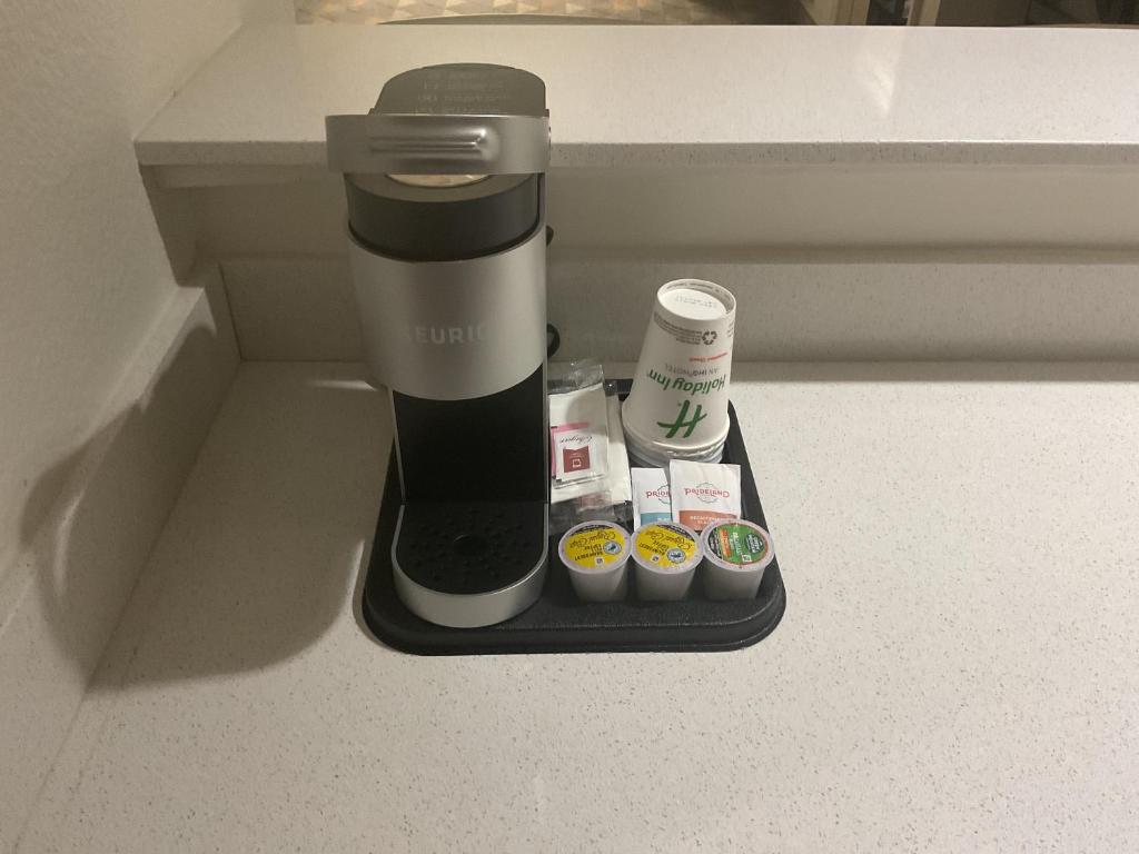a coffee maker sitting on a counter with muffins at Holiday Inn Houston Intercontinental Airport by IHG in Houston