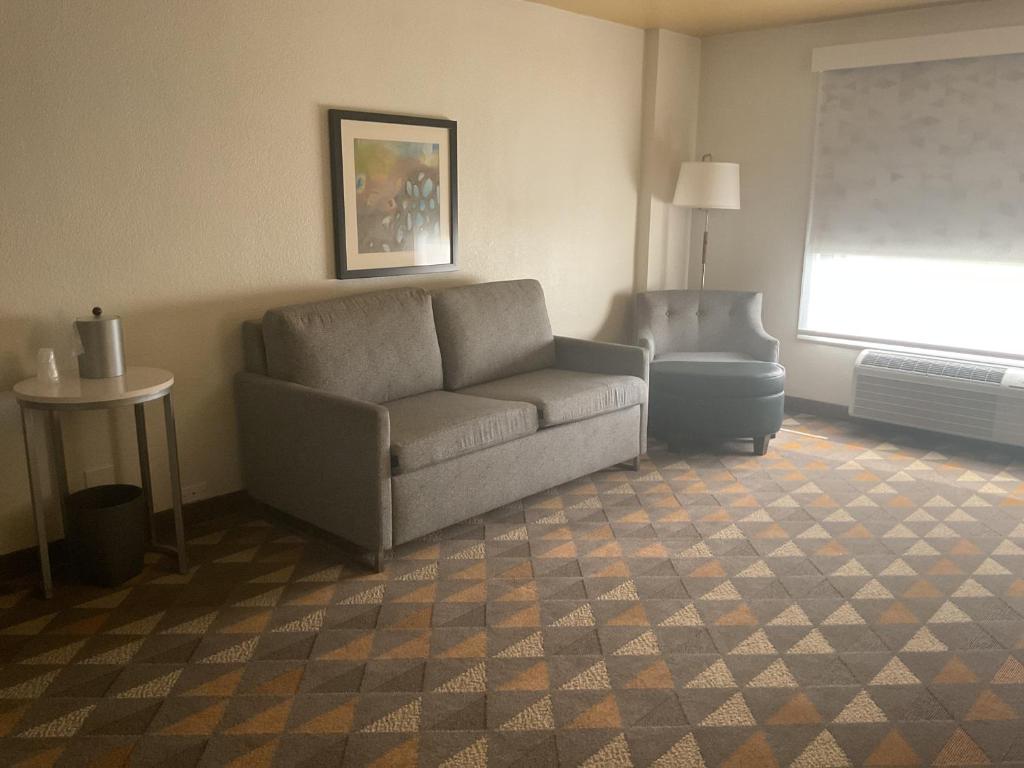 a living room with a couch and a chair at Holiday Inn Houston Intercontinental Airport by IHG in Houston