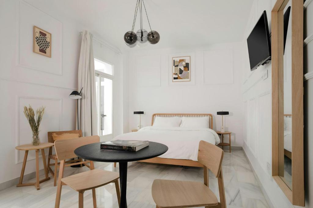Un dormitorio con una cama y una mesa y sillas. en Sonder by Marriott Bonvoy Santa Ana Apartments Las Letras, en Madrid
