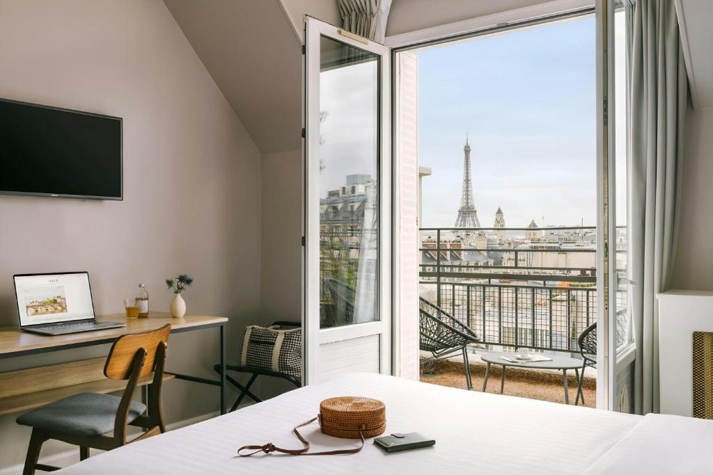 a hotel room with a view of the eiffel tower at Atala Hotel Champs Elysées, Sonder by Marriott Bonvoy in Paris