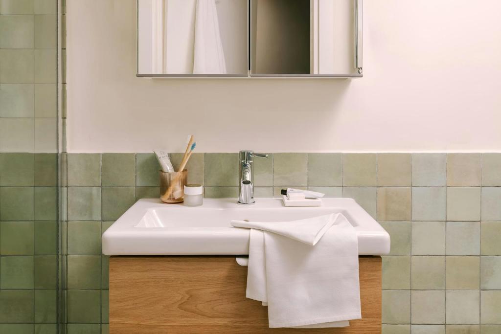 a bathroom with a white sink and a mirror at Testaccio Hotel Monte dei Cocci, Sonder by Marriott Bonvoy in Rome