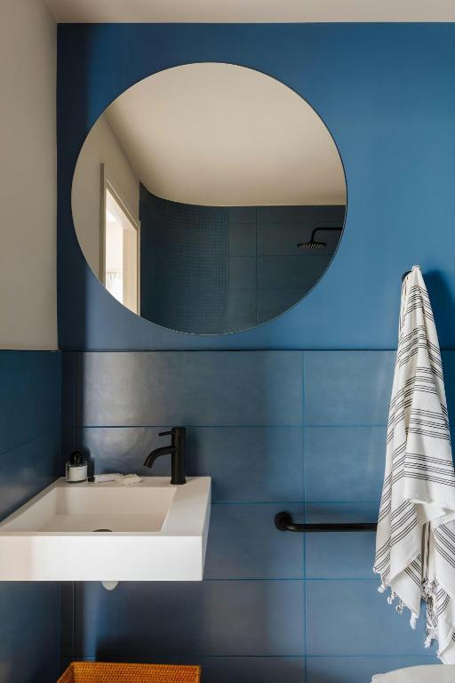 a bathroom with a white sink and a mirror at Yelo Promenade Hotel Magnan, Sonder by Marriott Bonvoy in Nice