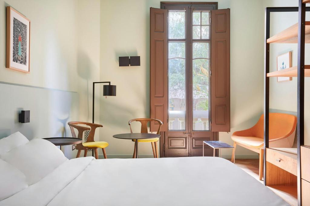 Postel nebo postele na pokoji v ubytování Le Palacete Hotel Gracia District, Sonder by Marriott Bonvoy