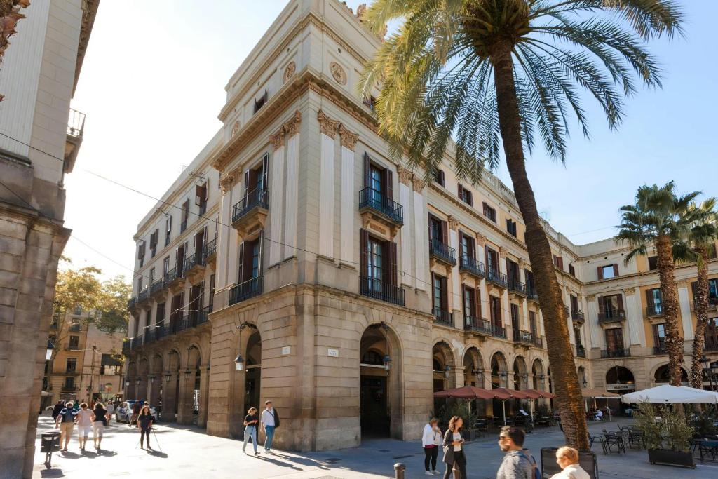 a building with a palm tree in front of it at DO Plaça Reial Hotel Gothic Quarter, Sonder by Marriott Bonvoy in Barcelona