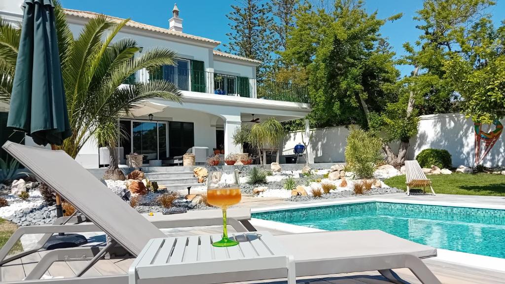 a villa with a swimming pool and a house at Luxury Casa Madeira, HEATED Salt Water Pool and Panoramic Woodfire Sauna in Lagos