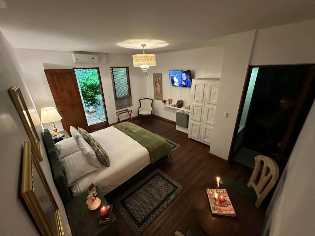 a bedroom with a bed and a living room at Leclerc Hotel Boutique Cali Granada in Cali