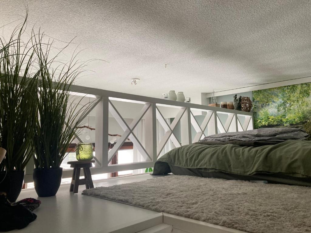 a bedroom with a bed and plants in it at Apartment for 5 people in Savonlinna