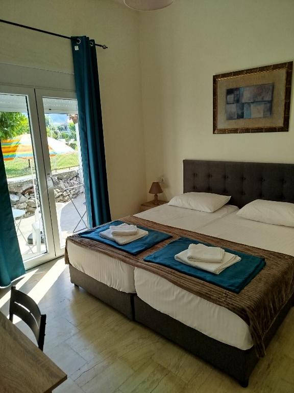a bedroom with a bed with two towels on it at Mirkashouse in Limenas