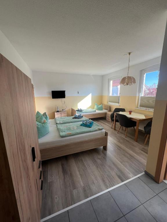 a bedroom with a bed and a living room at Ferienwohnungen Hennig in Ahlbeck