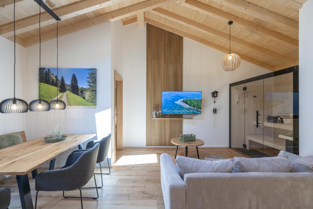 a living room with a couch and a table at Ferienwohnung "Mettmatalblick" mit privater Sauna, Ühlingen-Birkendorf in Ühlingen-Birkendorf