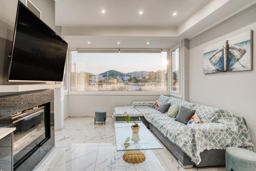a living room with a couch and a fireplace at Villa Elysian Komi in Kómi