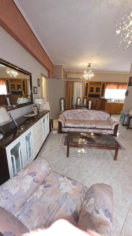 a living room with two beds and a table at Dimitris gerakas apartment in Mesochórion