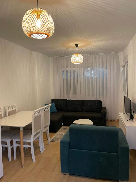 a living room with a couch and a table at Iris apartaments in Sakës